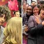 Timothée Chalamet standing in crowd